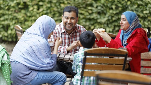 Visitors eating outside at Scotney Castle, Kent
